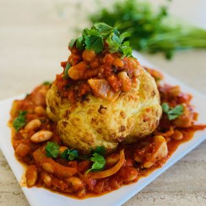 Whole roasted cauliflower with tomato, butter bean sauce